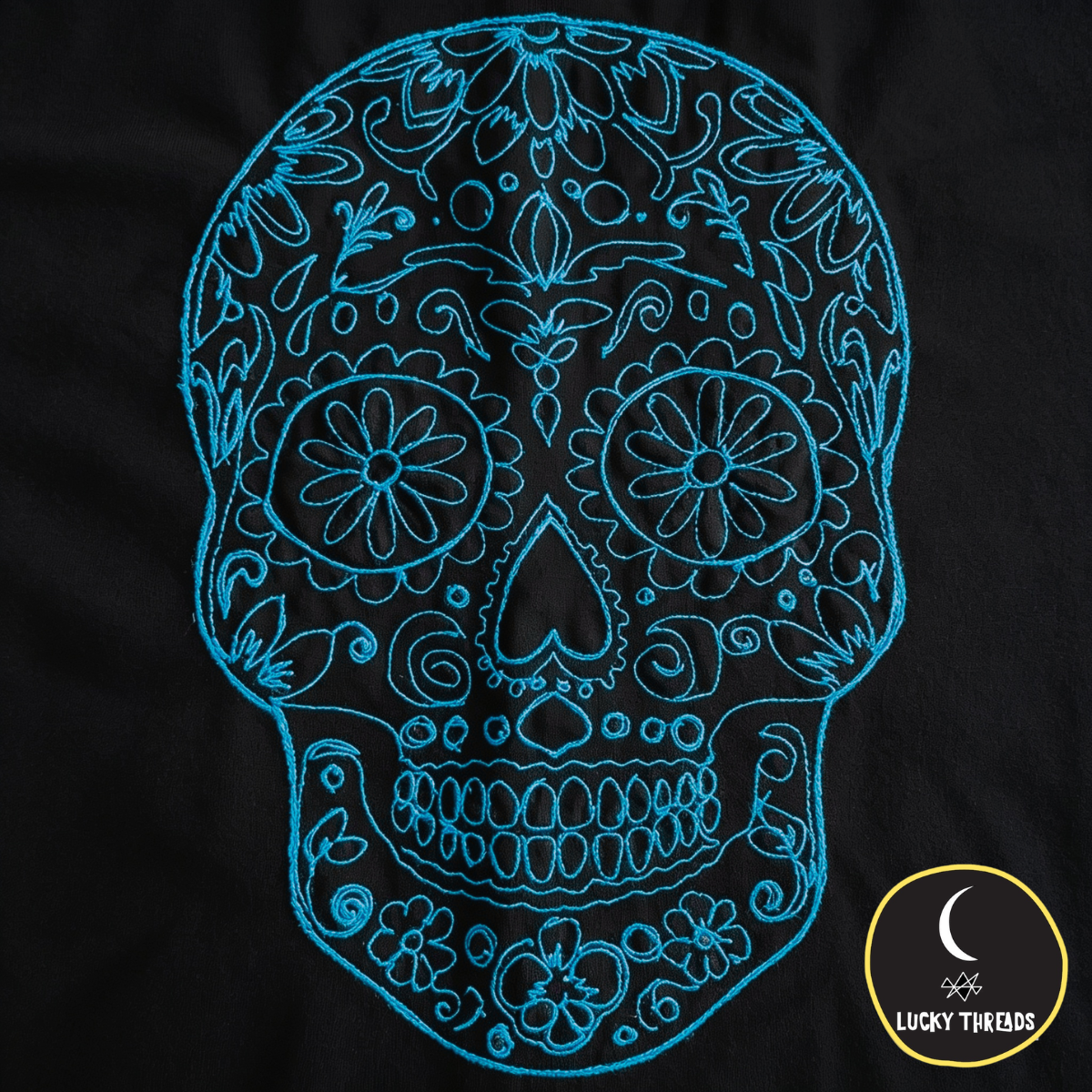 Turquoise skull on black Lucky Threads