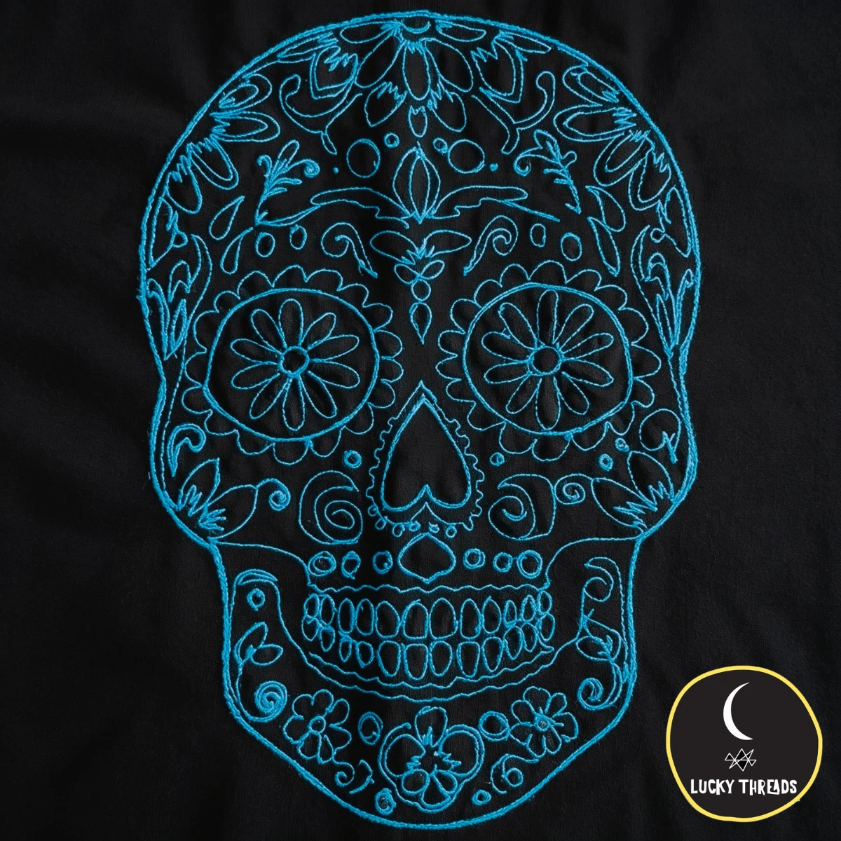 Turquoise skull on black Lucky Threads