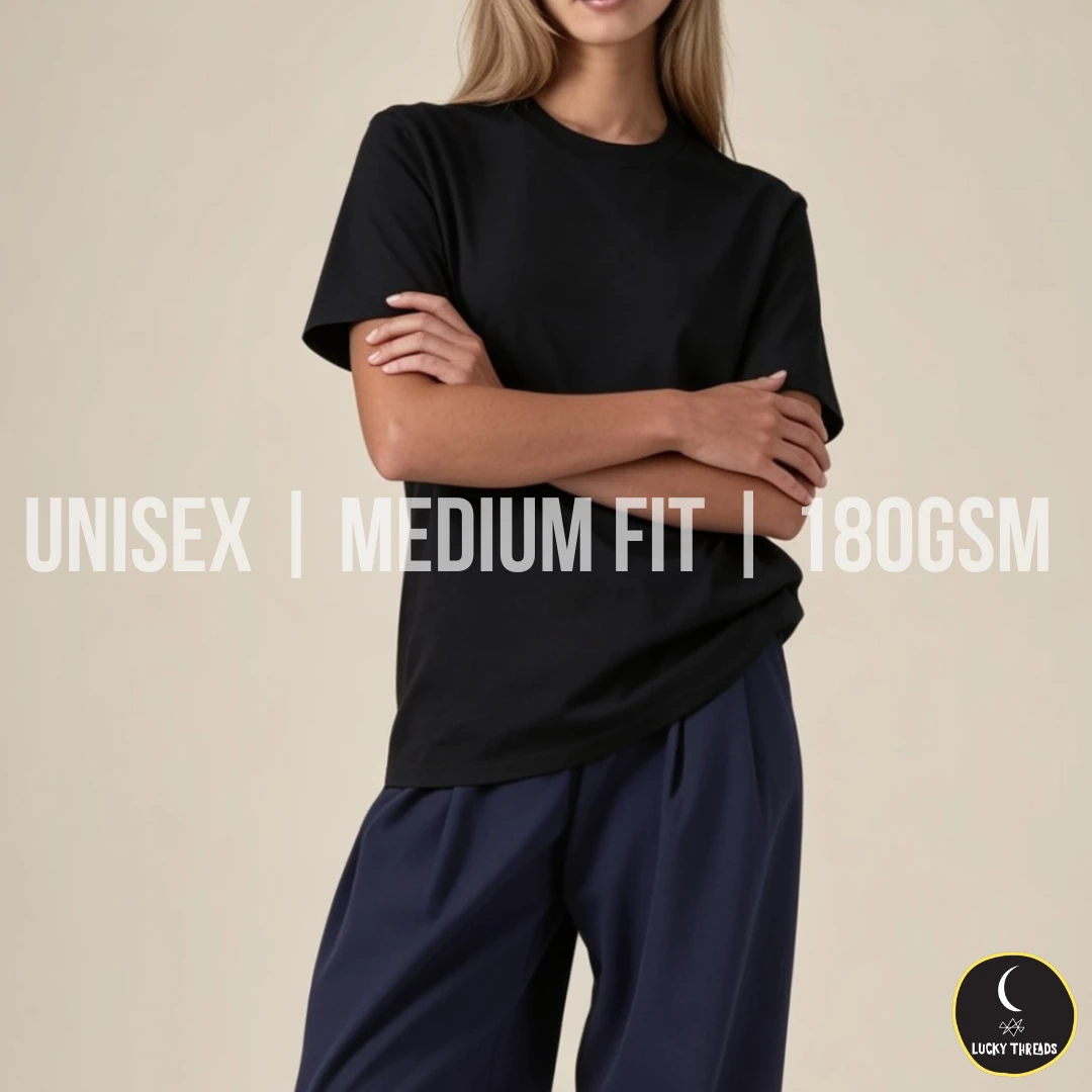 Unisex Medium Fit 180GSM Black unisex medium‑fit 180GSM T‑shirt worn by a model against a beige background.