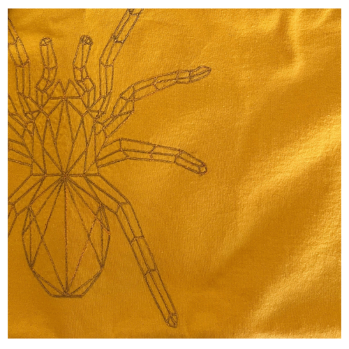 Yellow spider embroidery design on handmade stitched sweatshirt, free-motion thread art Close up