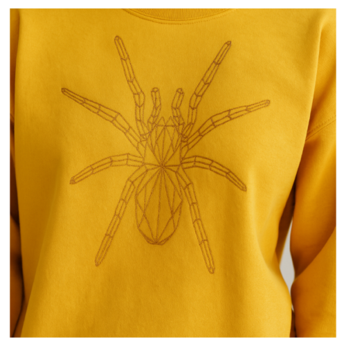 Yellow spider embroidery design on handmade stitched sweatshirt, free-motion thread art