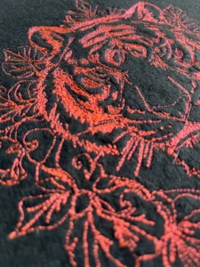 Close-up of floral big cat embroidery on handmade stitched sweatshirt by Lucky Threads