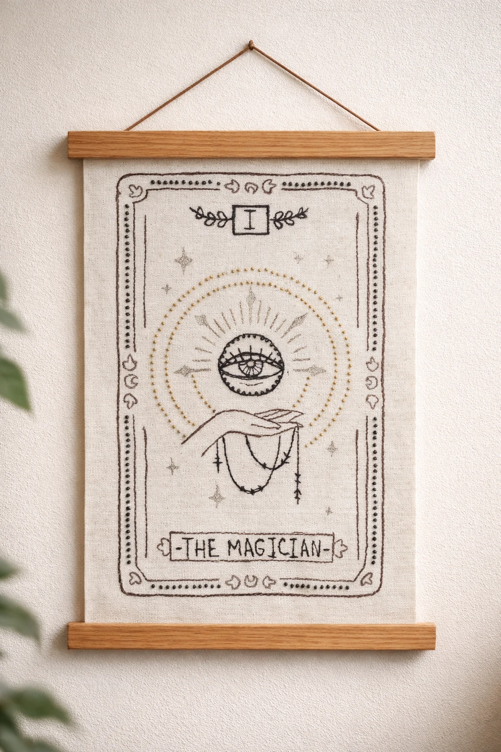 Hand-stitched Magician tarot wall hanging on an 11 × 14 inch (28 × 36 cm) canvas, shown unframed with free-motion embroidery and hand beading.