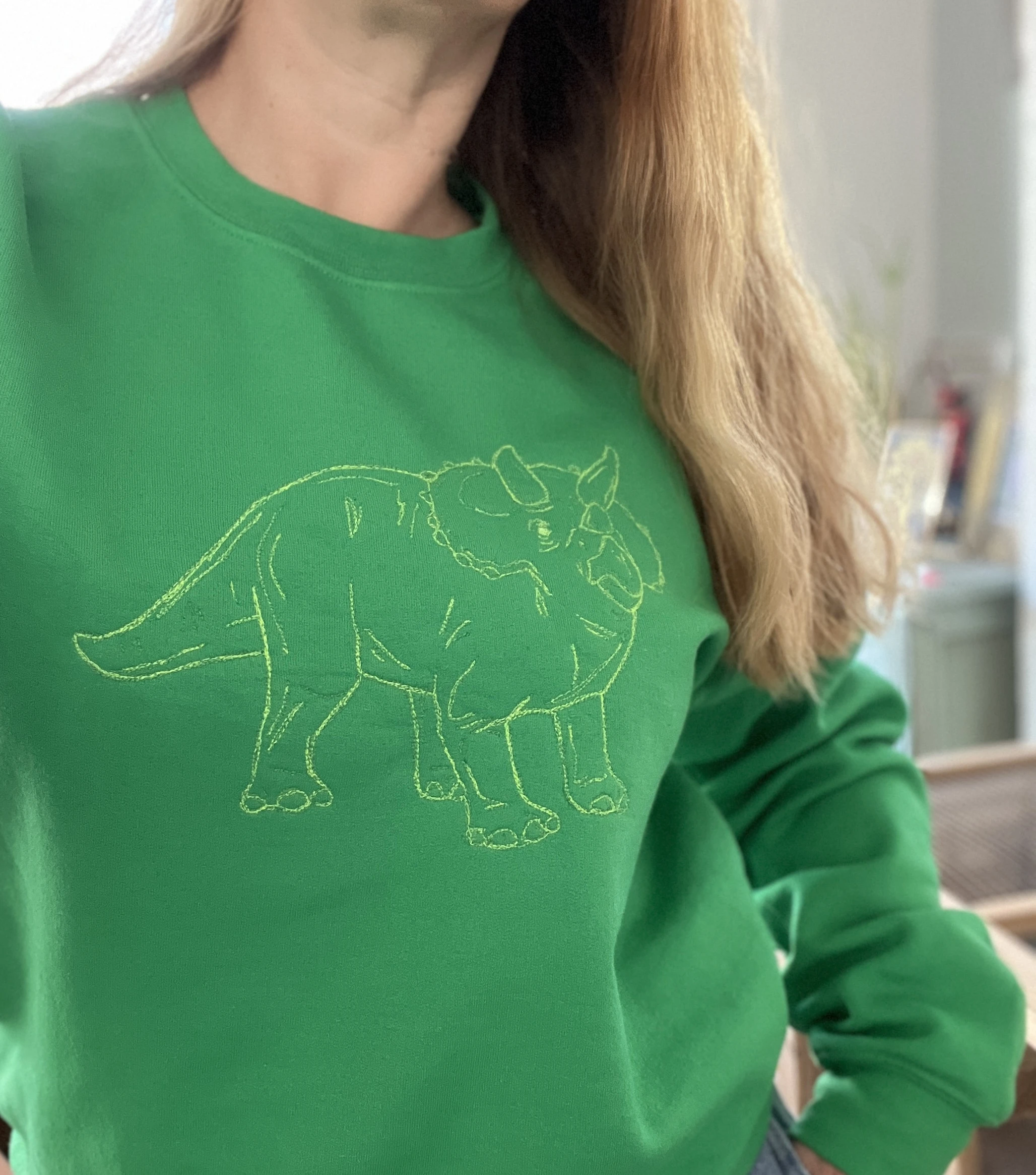 lucky threads dino on green sweater