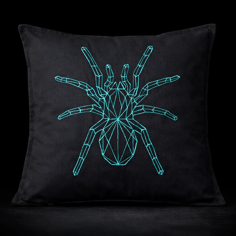 Geometric spider cushion cover in turquoise thread on black cotton